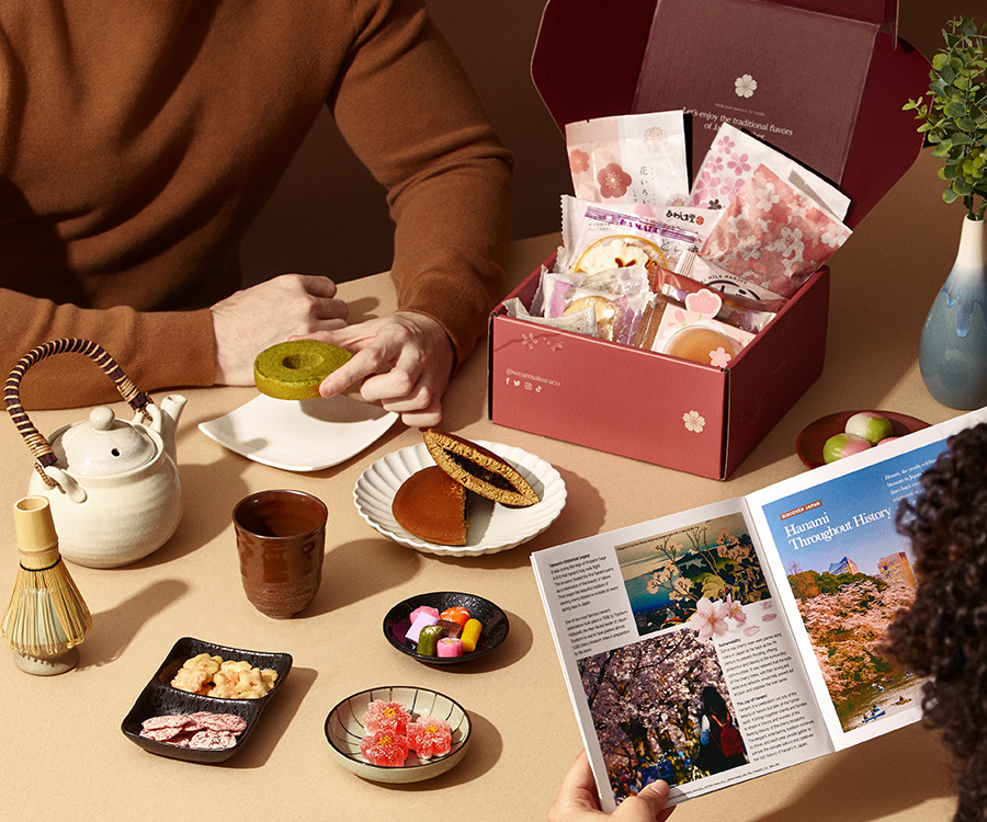 two persons sharing a Sakuraco box at a table